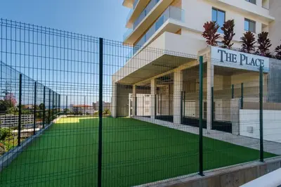 a fence in front of a building with a yard at GuestReady - The perfect place to relax in Funchal in Funchal