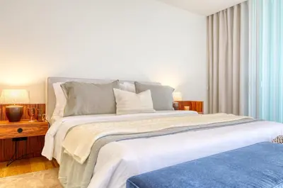 a bedroom with a large bed with a blue rug at Savoy Monumentalis, a Home in Madeira in Funchal