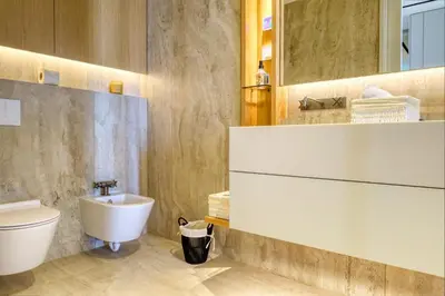 a bathroom with a sink and a toilet at Savoy Monumentalis, a Home in Madeira in Funchal