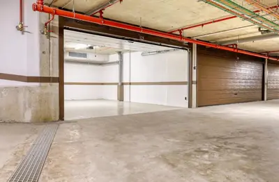 an empty garage with a wooden garage door at Savoy Monumentalis, a Home in Madeira in Funchal