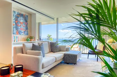 a living room with a white couch and a plant at Savoy Monumentalis, a Home in Madeira in Funchal