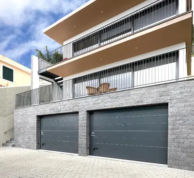 two garage doors in front of a house at Marco 4 Seasons- Autumn in Arco da Calheta