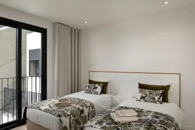 a hotel room with two beds and a balcony at Marco 4 Seasons- Autumn in Arco da Calheta