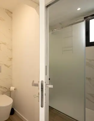 a glass shower door in a bathroom with a toilet at Marco 4 Seasons- Autumn in Arco da Calheta