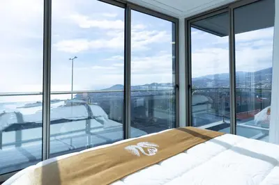 a bedroom with a bed and a large window at Villa Andrade Ocean View in Funchal