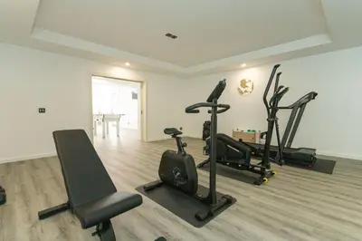 a gym with several treadmills and exercise bikes in a room at Villa Andrade Ocean View in Funchal