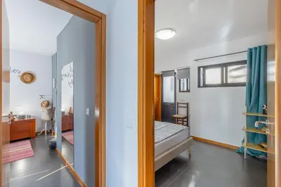 a bedroom with a bed and a mirror at FLH Funchal Sissi Lanço with View in Funchal