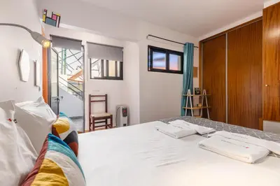 a bedroom with a large white bed and a window at FLH Funchal Sissi Lanço with View in Funchal