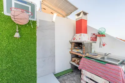 an outdoor kitchen with a basketball hoop and a grill at FLH Funchal Sissi Lanço with View in Funchal