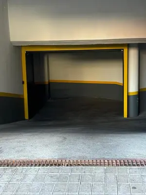 an empty garage with yellow doors in a building at 4 Saints apartement in Ribeira Brava