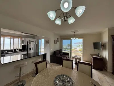 a living room with a dining table and a kitchen at 4 Saints apartement in Ribeira Brava