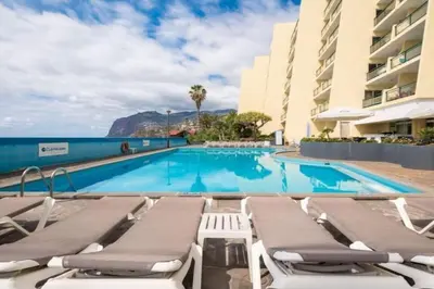 a living room with a couch and a table at Hip Heaven Apartment on Beach in Funchal