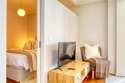 a bedroom with a bed and a table with a mirror at Elsa's Place, a Home in Madeira in Funchal