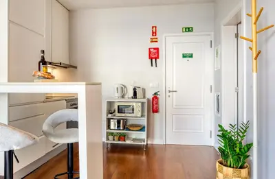 a kitchen with white walls and a white door at Elsa's Place, a Home in Madeira in Funchal