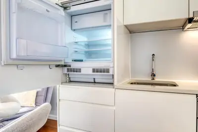 a kitchen with white cabinets and a sink at Elsa's Place, a Home in Madeira in Funchal