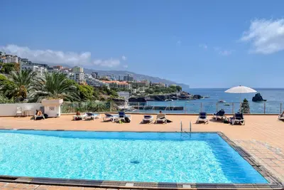 a swimming pool with a view of the ocean at Elsa's Place, a Home in Madeira in Funchal