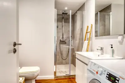 a bathroom with a shower and a toilet and a sink at Elsa's Place, a Home in Madeira in Funchal