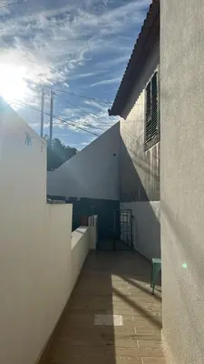 a balcony of a building with the sun in the sky at Villa R Relíquia in Machico