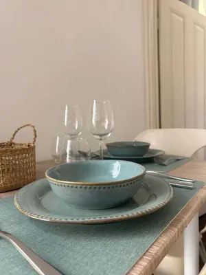 a table with two bowls and wine glasses on it at Villa R Relíquia in Machico
