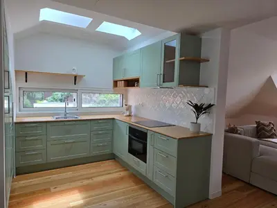 a kitchen with a wooden table and a sink at Ficus Suites in Ponta do Sol