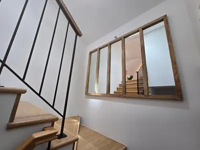a mirror on a wall next to a staircase at Ficus Suites in Ponta do Sol