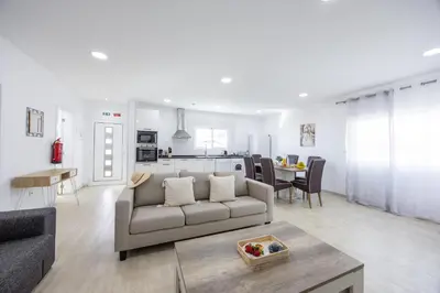 a living room with a couch and a table at Azur & Bellevue du Caniço by YOUR KEY in Caniço