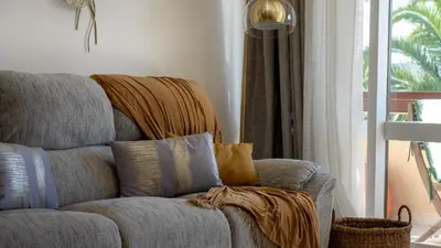 a living room with a couch with pillows on it at Solar do Mar by LovelyStay in Funchal