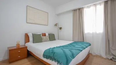 a bedroom with a large bed and a window at Solar do Mar by LovelyStay in Funchal