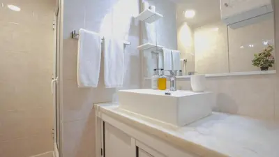 a white bathroom with a sink and a shower at Solar do Mar by LovelyStay in Funchal
