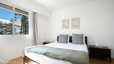 a white bedroom with a bed and a window at Solar do Mar by LovelyStay in Funchal