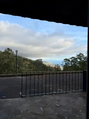 a view of a fence in front of a street at Habitación con estacionamiento y baño privado in Funchal