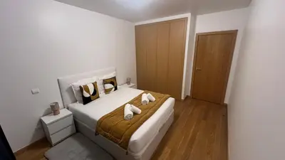 a bedroom with a bed with two towels on it at Paradisus guest house in Caniço