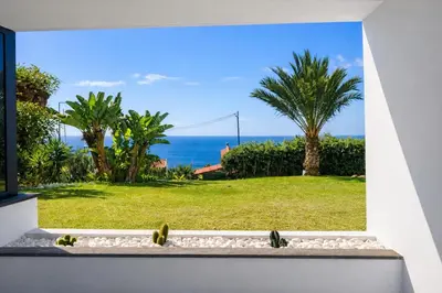 a window view of the ocean from a house at Paradisus guest house in Caniço
