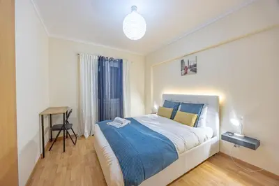 a bedroom with a bed with two towels on it at Machico Apt Moderno Familias ou Grupos in Machico