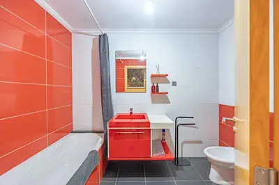 two mirrors on a wall with a floral wallpaper at Machico Apt Moderno Familias ou Grupos in Machico