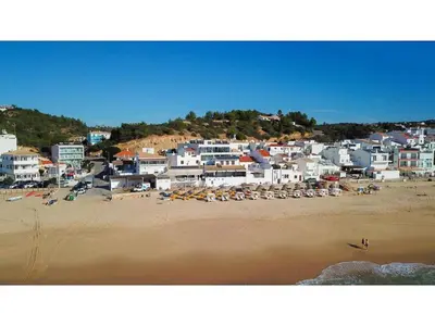 a view of a beach with a group of buildings at Casa Dourada - Golden Beach Apt in Budens