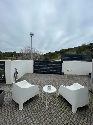 two white chairs and a table on a patio at SalemaView Ensuite bedroom in Salema