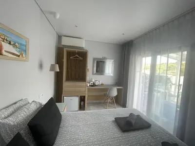 a bedroom with a bed and a desk and a window at SalemaView Ensuite bedroom in Salema