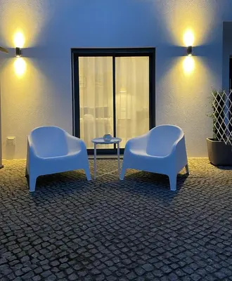 two blue chairs and a table in a room at SalemaView Ensuite bedroom in Salema