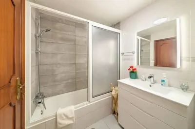 a bathroom with a shower and a sink and a mirror at Gorete Apartment by Mth in Funchal