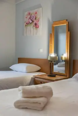 a hotel room with two beds and a mirror at Gorete Apartment by Mth in Funchal