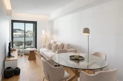 a living room with a couch and a table and chairs at Acqua Residence IV by An Island Apart in Funchal