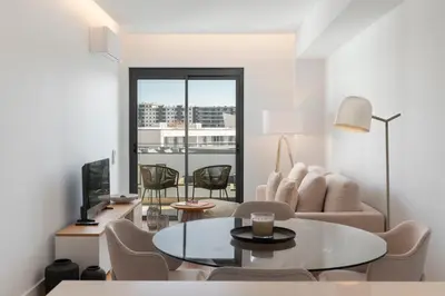 a living room with a table and chairs at Acqua Residence IV by An Island Apart in Funchal