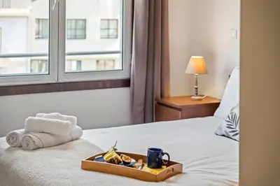 a tray of food on a bed with a window at Maderia Emotions I, By OP in Funchal
