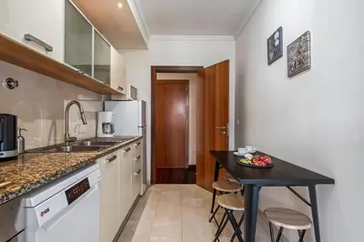 a kitchen with a black counter top and a table at Maderia Emotions I, By OP in Funchal