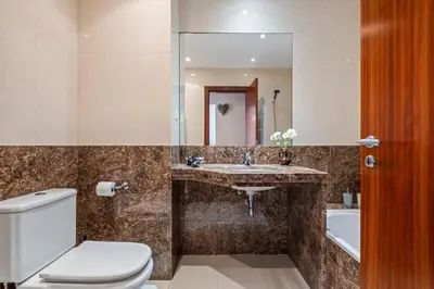 a bathroom with a toilet and a sink and a mirror at Maderia Emotions I, By OP in Funchal