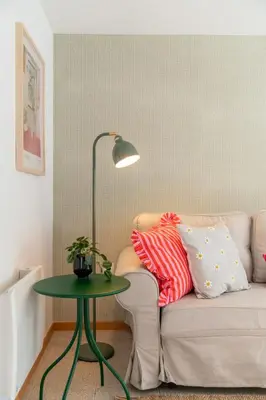 a living room with a couch and a green table at Casa Afonso by An Island Apart in Santana