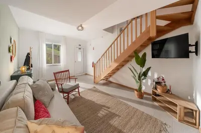 a living room with a couch and a tv at Casa Afonso by An Island Apart in Santana