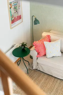a living room with a couch and a green table at Casa Afonso by An Island Apart in Santana