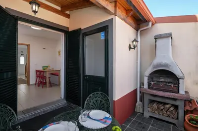 a patio with a wood stove in a house at Casa Afonso by An Island Apart in Santana
